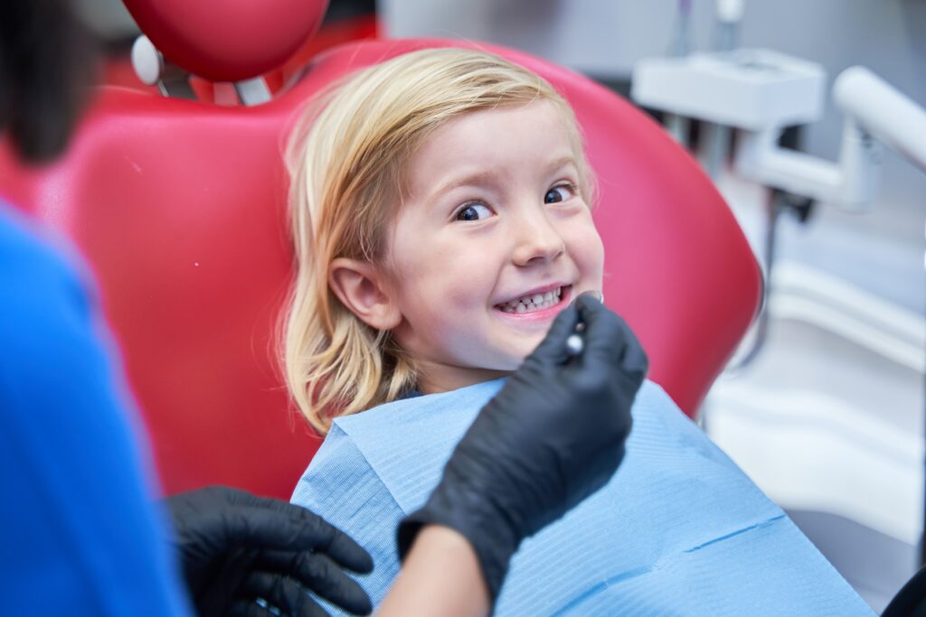 Child at orthodontic check-up: A young child during an orthodontic check-up, highlighting the importance of early assessments for healthy smiles.